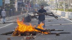 Image: A protester sets fire to block traffic in Gauhati, India