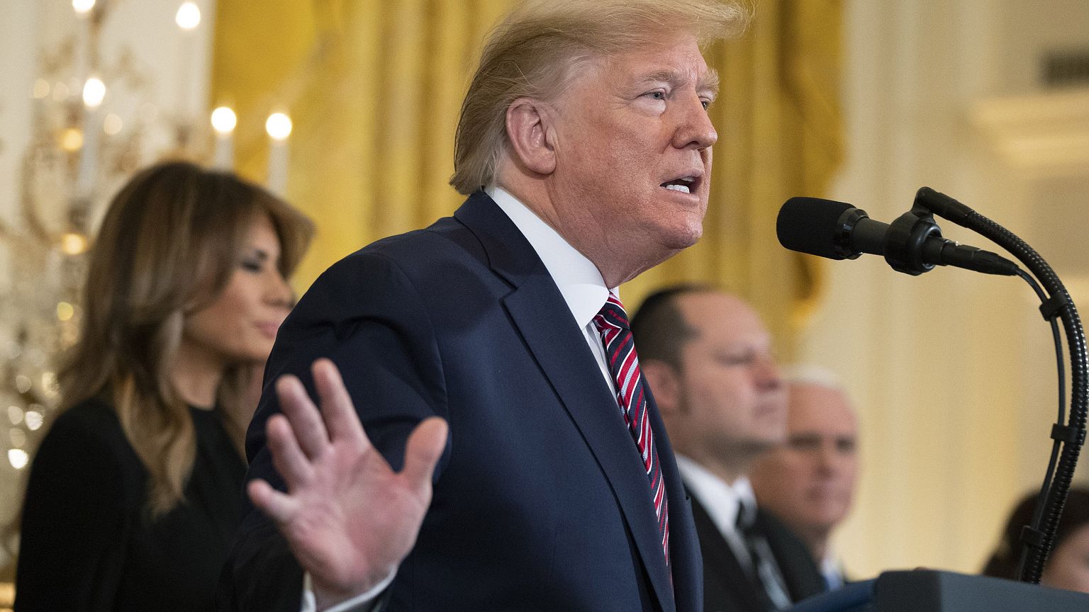 Image: President Donald Trump, with first lady Melania Trump, speaks during