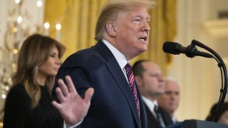 Image: President Donald Trump, with first lady Melania Trump, speaks during