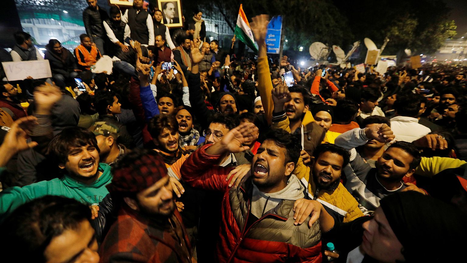 Image: Demonstrators shout slogans during a protest against a new citizensh