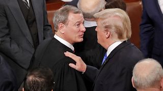 U.S. President Trump greets Justice Roberts after delivering his State of t
