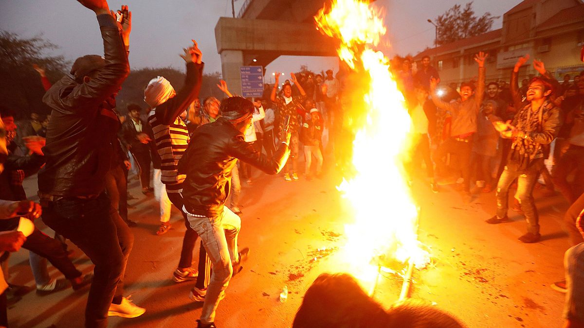 Image: Demonstrators burn an effigy depicting PM Modi during a protest agai