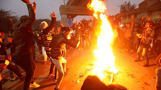 Image: Demonstrators burn an effigy depicting PM Modi during a protest agai