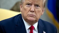 Image: President Donald Trump listens to questions in the Oval Office on De