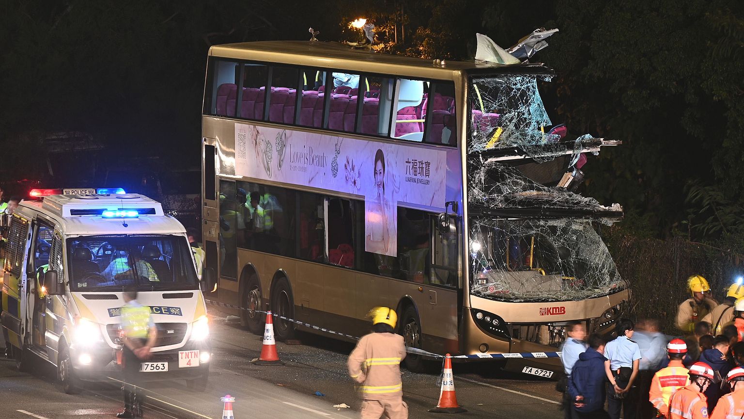Image: Firefighters, medics and police gather near a double-decker bus afte