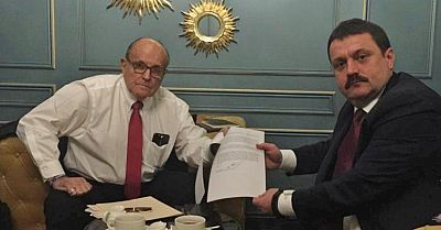 Ukrainian lawmaker Andrii Derkach and President Donald Trump\'s personal lawyer Rudolph Giuliani show a document during a meeting in Kiev in this picture obtained from social media.