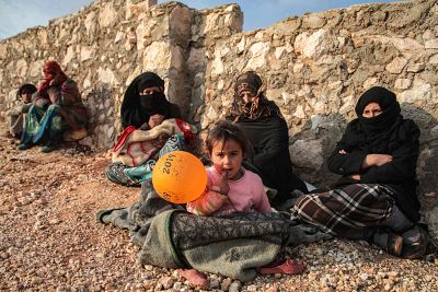 Displaced civilians from the south of Idlib province sit out in the open in the war-torn northwestern Syrian region on Monday.