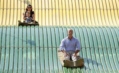 Rep. John Delaney, D-Md., rides down the giant slide during a visit to the Iowa State Fair on Aug. 10, 2018, in Des Moines, Iowa.