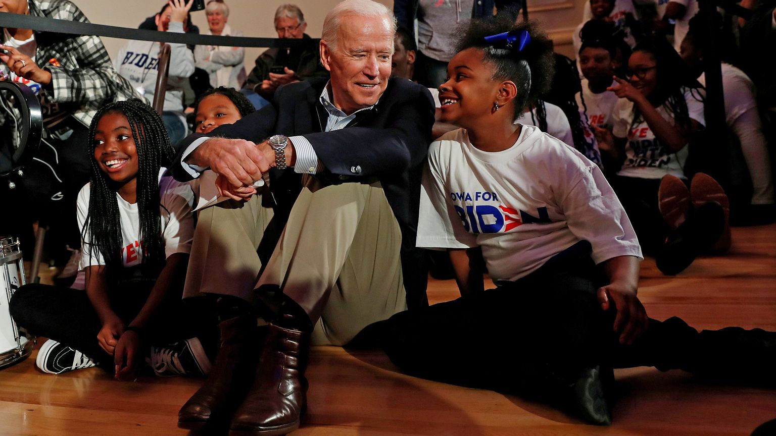 Former Vice President Joe Biden sits with kids from the Union Baptist Crusa