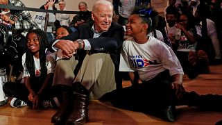 Former Vice President Joe Biden sits with kids from the Union Baptist Crusa