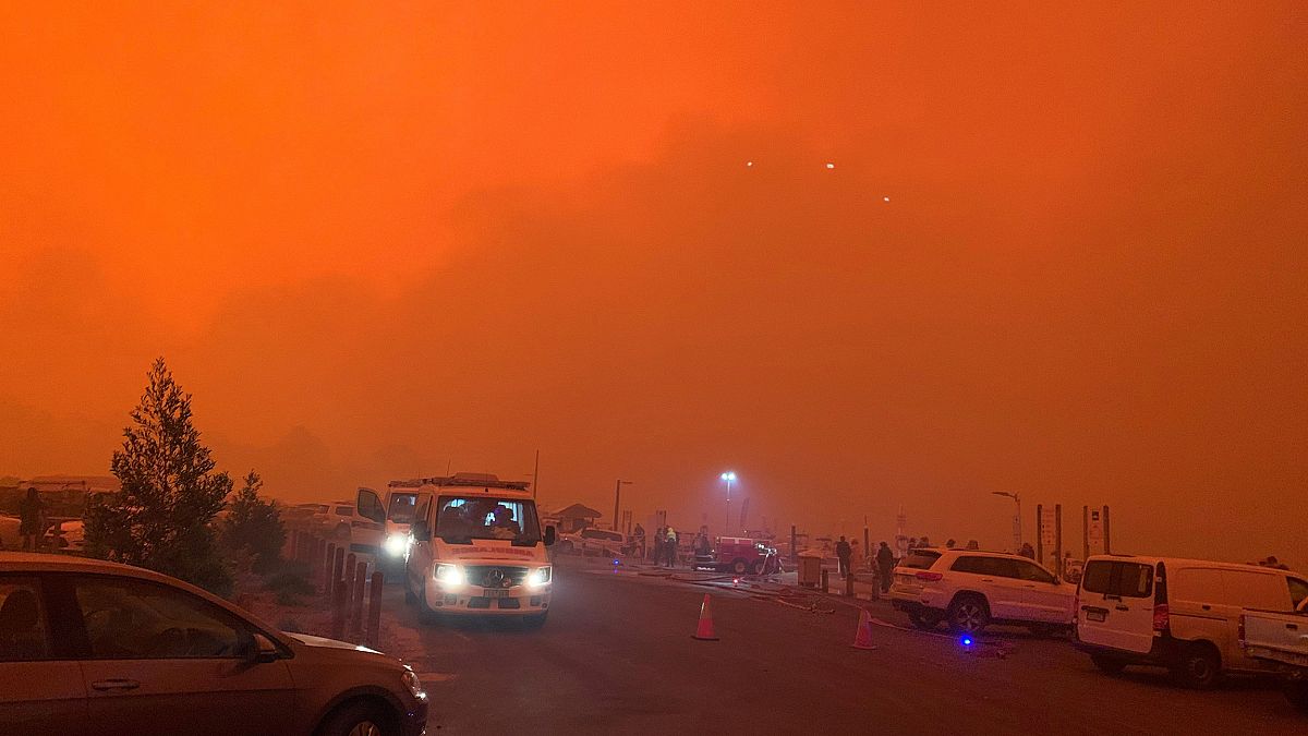 Image: The sky glows red as bushfires continue to rage in Mallacoota, Victo