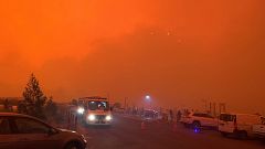Image: The sky glows red as bushfires continue to rage in Mallacoota, Victo