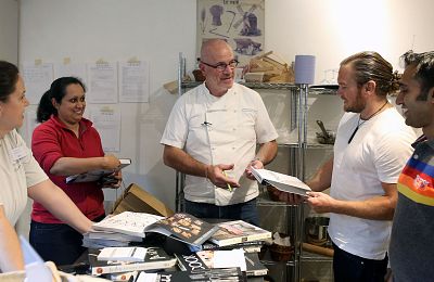 French Chef Richard Bertinet signs copies of his cookery books for students at his cooking school in Bath, Somerset, United Kingdom. 