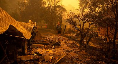 Gary Hinton stands in the rubble after fires devastated the town of Cobargo, Australia, on Dec. 31.