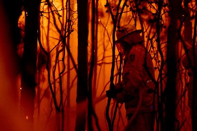 A firefighter battles a bush fire near the town of Sussex Inlet on Dec. 31.