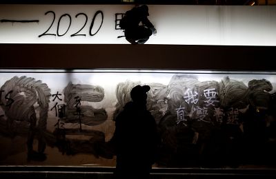 An anti-government protester paints graffiti during a demonstration on New Year\'s Day to call for better governance and democratic reforms in Hong Kong.