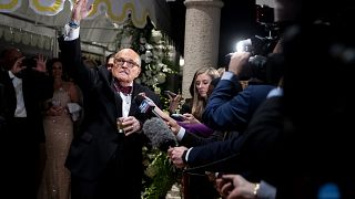 Image: Rudy Giuliani speaks to the press at a New Year's Eve party hosted b