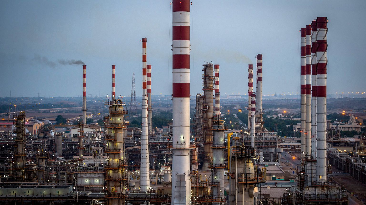 Image: Lights illuminate the processing plant at the Persian Gulf Star Co. 