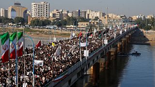 Image: People attend a funeral procession for Soleimani and al-Muhandis, in