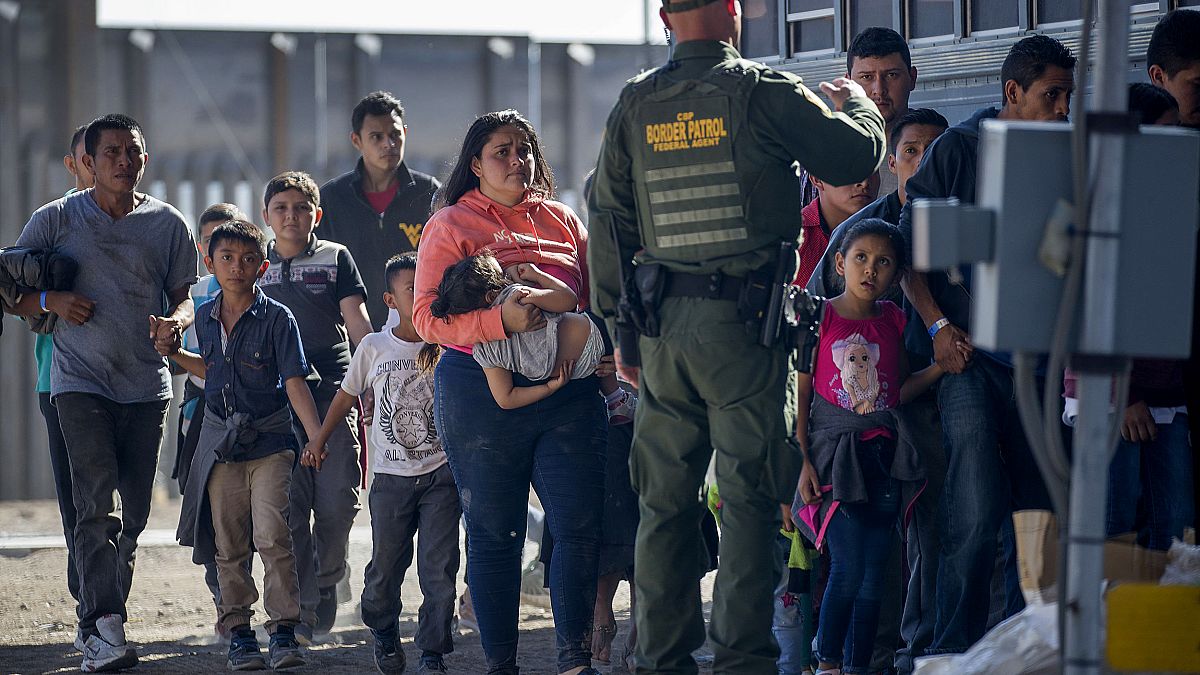 Image: Migrants are loaded onto a bus by Border Patrol agents in El Paso, T