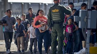 Image: Migrants are loaded onto a bus by Border Patrol agents in El Paso, T