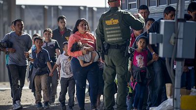 Image: Migrants are loaded onto a bus by Border Patrol agents in El Paso, T Image: Migrants are loaded onto a bus by Border Patrol agents in El Paso, T