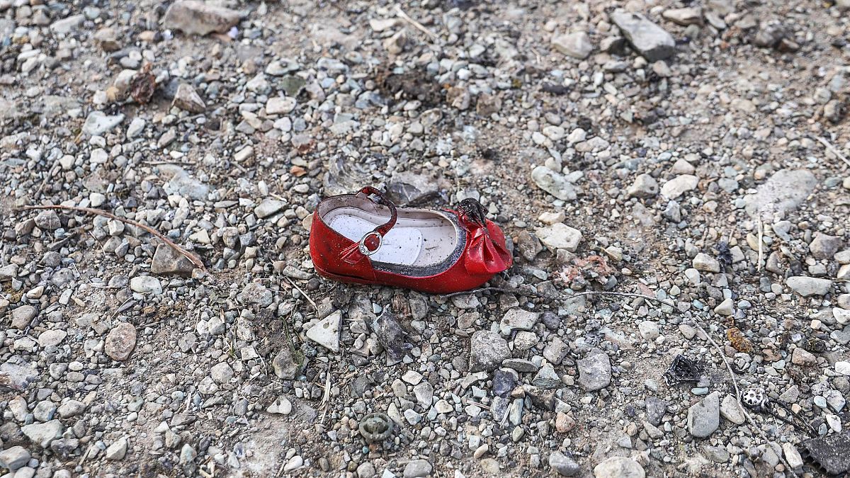 Image: A child's shoe at the scene of a Ukrainian airliner that crashed sho