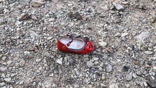 Image: A child's shoe at the scene of a Ukrainian airliner that crashed sho