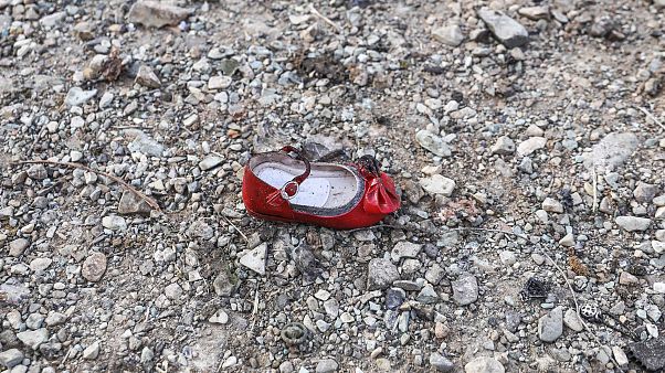 Image: A child's shoe at the scene of a Ukrainian airliner that crashed sho Image: A child's shoe at the scene of a Ukrainian airliner that crashed sho