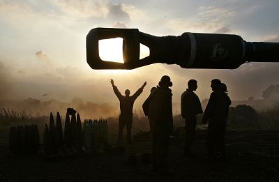 Israeli gunners gather at an artillery piece as it is prepared to fire into southern Lebanon from a position near Kiryat Shmona, in July 2006.