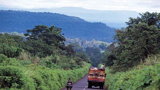 A local bus on a road in the lush Boloven Plateau in southern Laos.