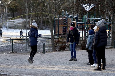 Students at Orminge Skola elementary school in Stockholm play outside despite the cold as part of a broader educational philosophy that fosters a love for nature.