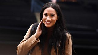 Image: Britain's Meghan, Duchess of Sussex reacts as she arrives to visit C