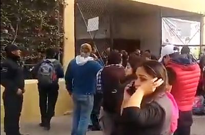 People gather outside the school where at least two people were killed and four injured in a shooting in the northern Mexican city of Torreon on Jan. 10, 2020.