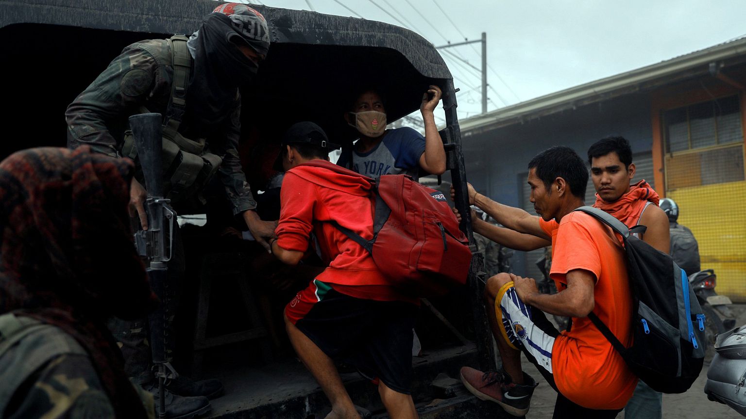 Image: Residents living near the erupting Taal Volcano are evacuated in Ago