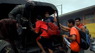Image: Residents living near the erupting Taal Volcano are evacuated in Ago