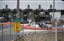 Image: A man gets out of his vehicle to see what the backup is at the toll