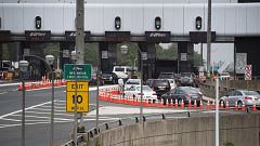 Image: A man gets out of his vehicle to see what the backup is at the toll 