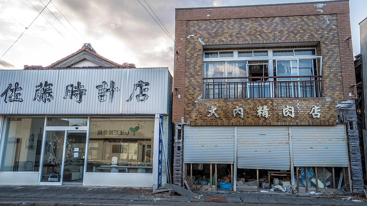 Image: Futaba's clock shop, left, and butcher shop in the still uninhabitab