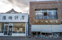 Image: Futaba's clock shop, left, and butcher shop in the still uninhabitab