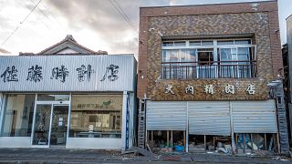 Image: Futaba's clock shop, left, and butcher shop in the still uninhabitab