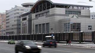 Image: Cars drive past the headquarters of the Russian General Staff's Main