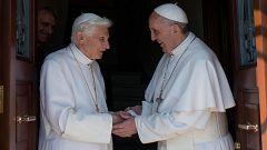 Image: Pope emeritus Benedict XVI, left, is welcomed by Pope Francis as he 