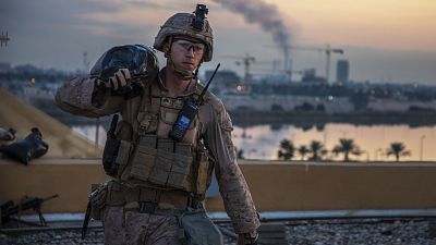 A U.S. Marine with 2nd Battalion, 7th Marines, carries a sand bag during the reinforcement of the U.S. embassy compound in Baghdad last week.