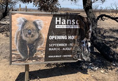 A burned sign sits on the road outside the Hanson Bay Wildlife Sanctuary. 