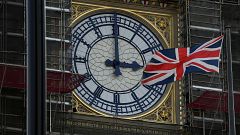 Image: FILE PHOTO: British Union Jack flies in front of the clock face of t