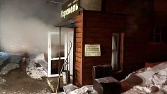 Image: Steam comes out from a door of the Mini Hotel Caramel after a hot wa
