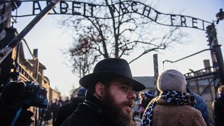 Image: Rabbi Shlomo Koves walks by the main gate of the former Auschwitz co