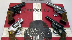 Image: Weapons and a sign of the neo-Nazi group Combat 18 seized by the pol