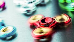 Fidget Spinner. Several colorful fidget spinners on a stainless steel plate